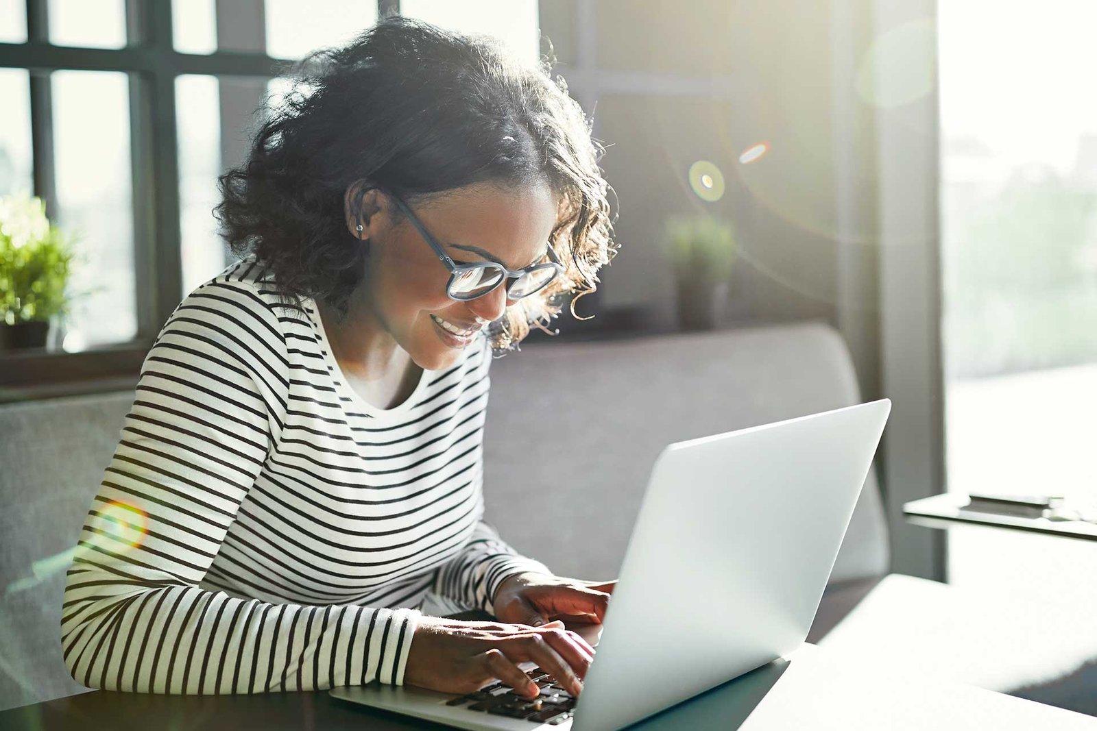 smiling-young-african-woman-working-online