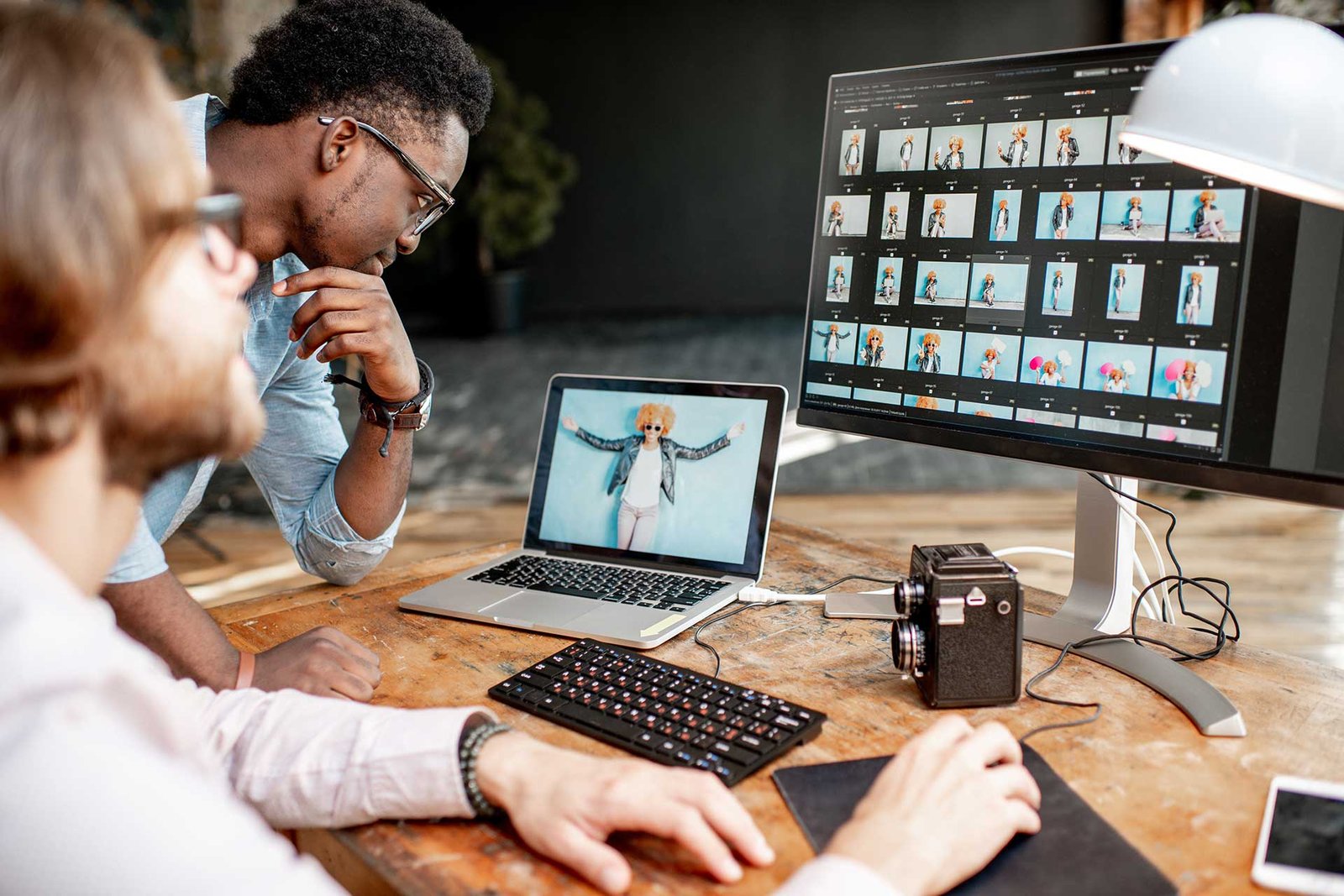 two-photographers-working-on-the-computers
